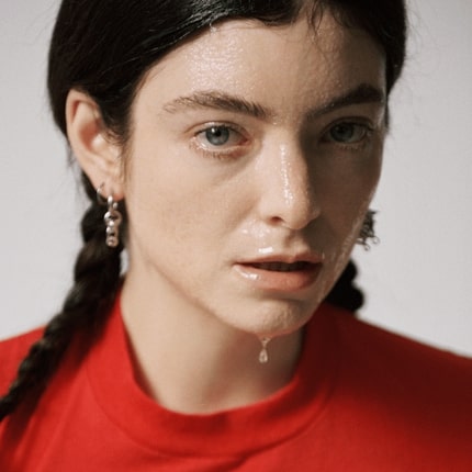 The cover art for Lorde’s “What Was That” features a haunting, close-up portrait drenched in sweat, capturing the raw vulnerability and emotional intensity of her new era. (credit to Genius Lyrics)